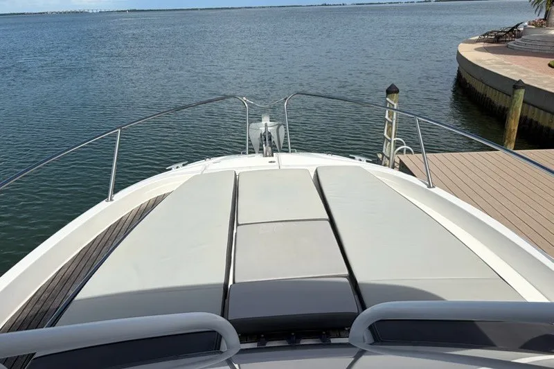 Slide: The Image of 2019 Jeanneau Leader 9.0 WA boat with sunbathing deck, docked by calm waters. - 20