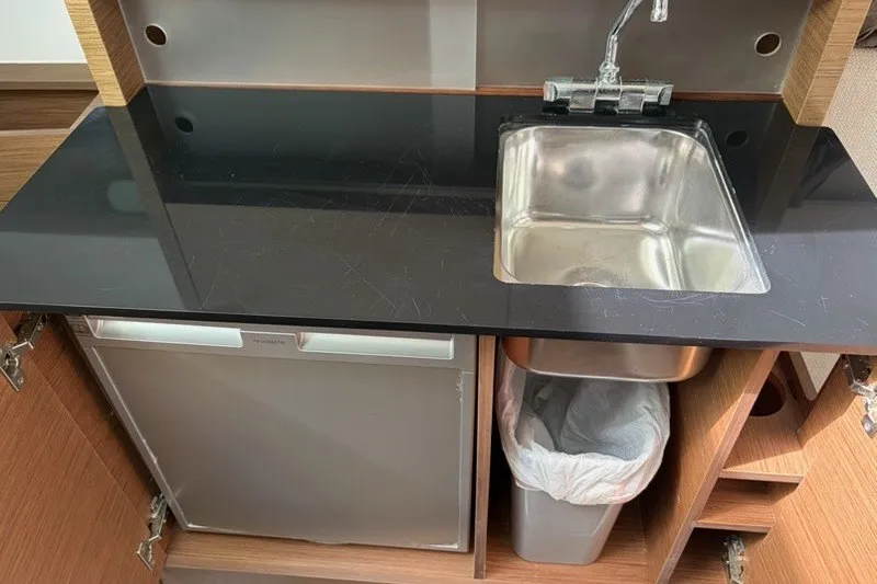 Slide: The Image of Compact kitchenette in 2019 Jeanneau Leader 9.0 WA with sink and mini fridge. - 14