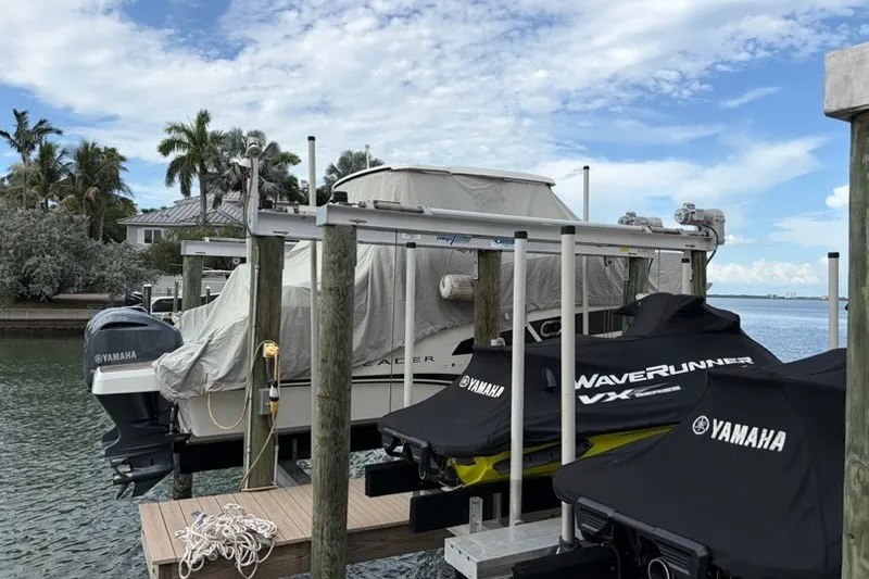 Slide: The Image of 2019 Jeanneau Leader 9.0 WA and Yamaha WaveRunners docked by waterfront. - 1