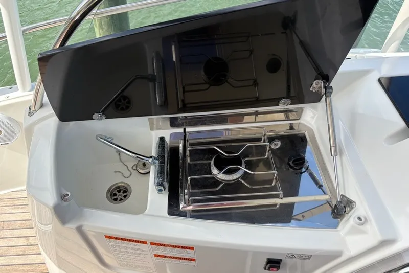 Slide: The Image of Outdoor kitchenette on a 2019 Jeanneau Leader 9.0 WA boat with stove and sink. - 9