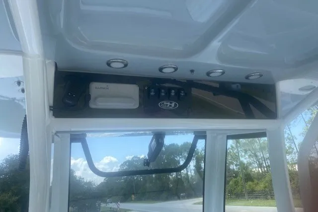 Slide: The Image of 2022 Sea Hunt Gamefish 27CB boat interior with control panel and overhead lighting. - 16