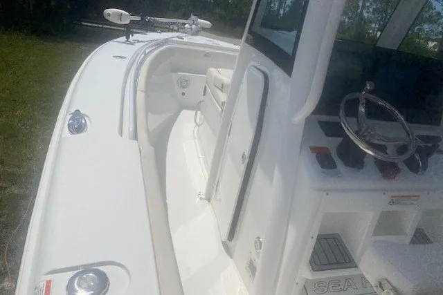 Slide: The Image of 2022 Sea Hunt Gamefish 27CB boat interior with steering wheel and seating. - 14