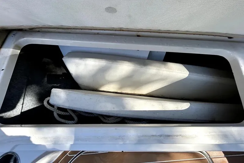 Slide: The Image of Storage compartment on a 2007 Sea Ray 260 Sundeck, containing boat fenders and rope. - 55