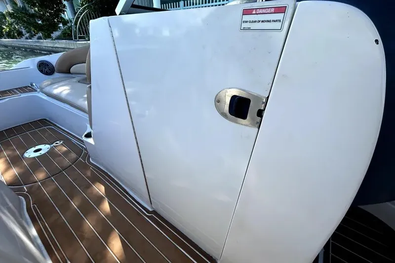 Slide: The Image of 2007 Sea Ray 260 Sundeck boat interior with teak flooring and cushioned seating. - 70