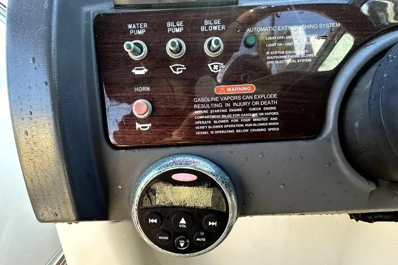 Slide: The Image of Control panel of a 2007 Sea Ray 260 Sundeck boat with warning labels and switches. - 66