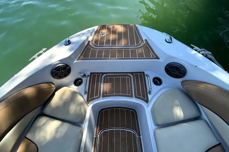 Slide: The Image of 2007 Sea Ray 260 Sundeck boat interior with cushioned seating and wood accents. - 15