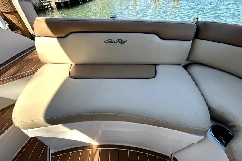 Slide: The Image of 2007 Sea Ray 260 Sundeck boat seating with logo, overlooking water. - 39