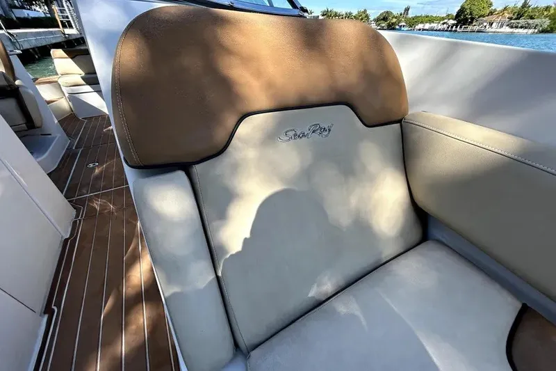 Slide: The Image of 2007 Sea Ray 260 Sundeck interior with tan and cream seating, featuring embroidered logo. - 58