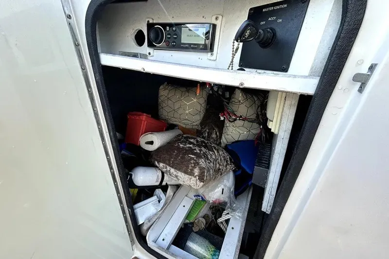 Slide: The Image of Storage compartment of a 2007 Sea Ray 260 Sundeck with various boating accessories. - 59
