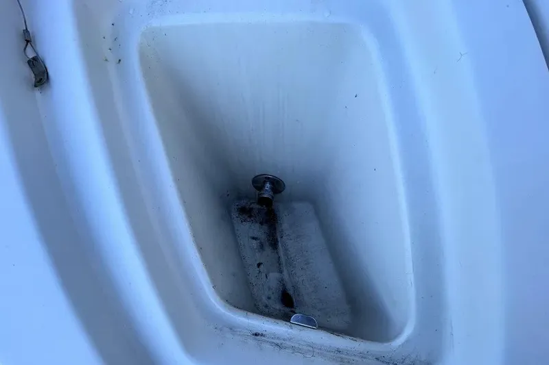 Slide: The Image of Storage compartment of a 2007 Sea Ray 260 Sundeck boat, showing wear and dirt. - 30