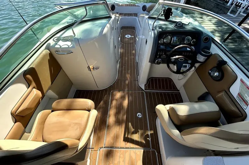 Slide: The Image of 2007 Sea Ray 260 Sundeck interior with tan seating and wood flooring. - 19