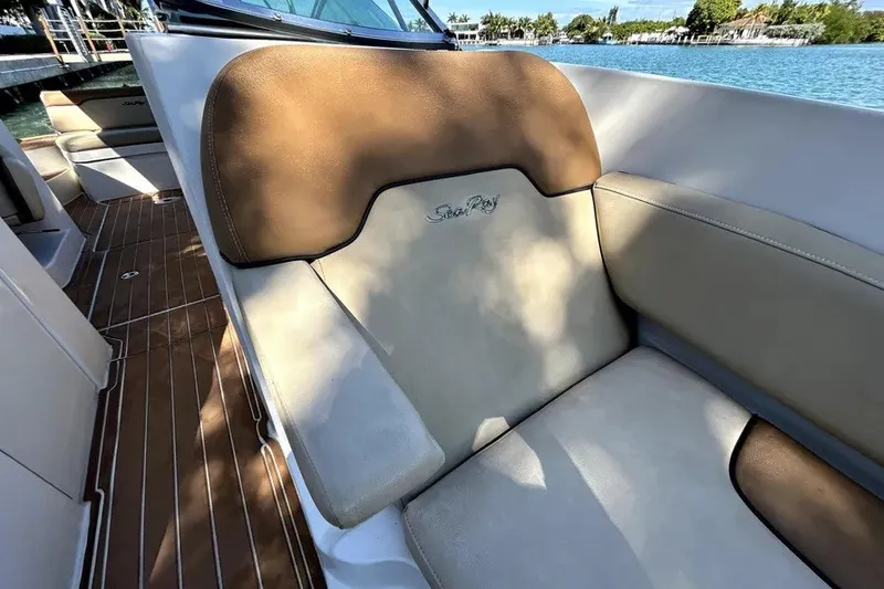 Slide: The Image of 2007 Sea Ray 260 Sundeck boat interior with tan seating and wood flooring. - 83