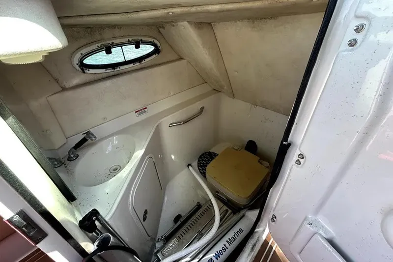 Slide: The Image of 2007 Sea Ray 260 Sundeck interior bathroom with sink and portable toilet. - 72