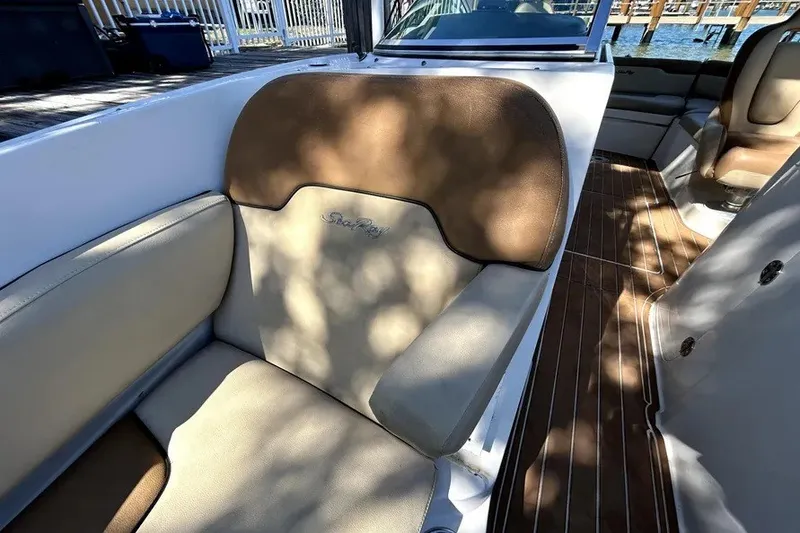 Slide: The Image of 2007 Sea Ray 260 Sundeck interior with cushioned seating and wooden flooring. - 80