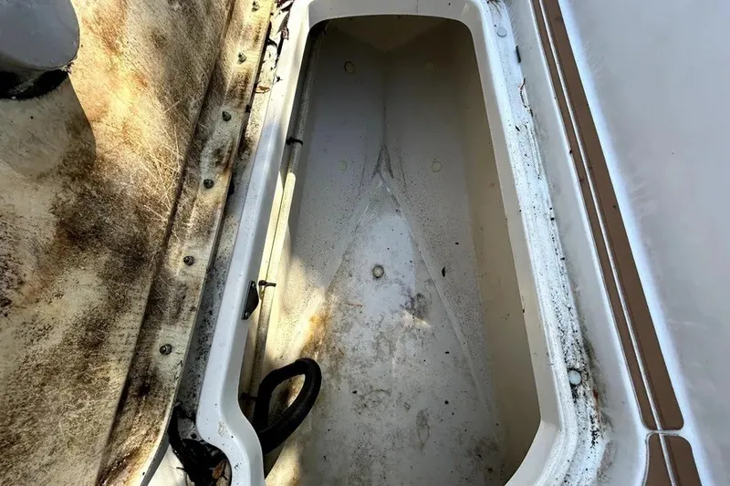 Slide: The Image of Storage compartment of a 2007 Sea Ray 260 Sundeck boat, showing wear and dirt. - 75