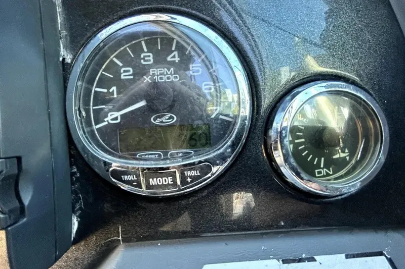 Slide: The Image of Dashboard gauges of a 2007 Sea Ray 260 Sundeck boat, showing RPM and trim indicators. - 62