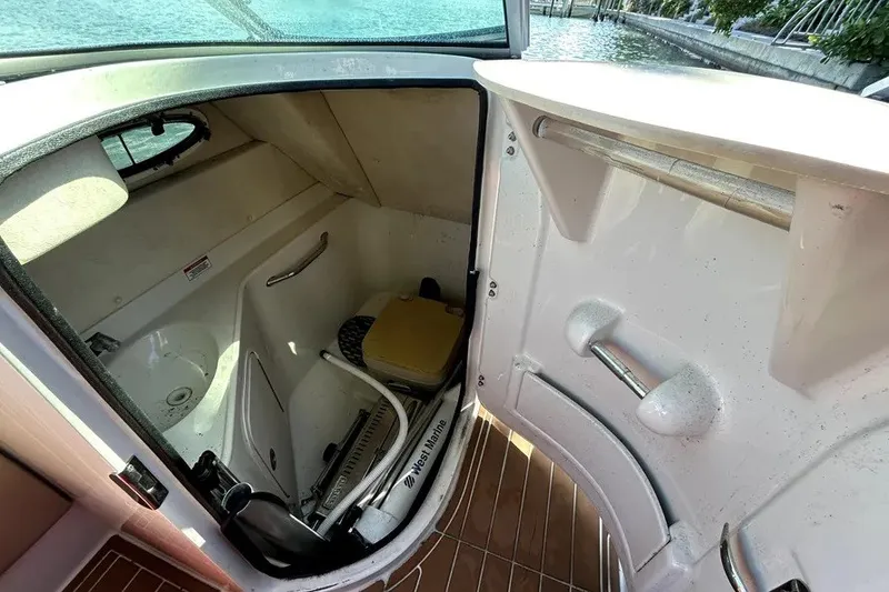 Slide: The Image of Interior view of 2007 Sea Ray 260 Sundeck boat's compact bathroom area. - 73