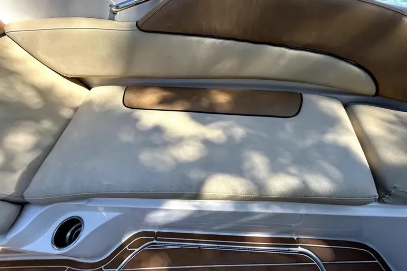 Slide: The Image of 2007 Sea Ray 260 Sundeck boat seating with beige cushions and wood accents. - 77