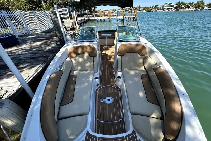 Slide: The Image of 2007 Sea Ray 260 Sundeck boat docked, featuring spacious seating and elegant design. - 13