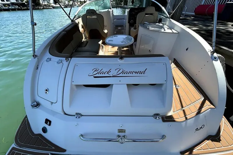 Slide: The Image of 2007 Sea Ray 260 Sundeck boat, "Black Diamond," docked with spacious seating and table. - 23