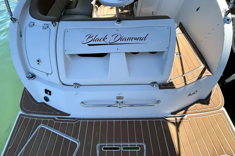 Slide: The Image of 2007 Sea Ray 260 Sundeck boat, "Black Diamond," with teak deck and seating area. - 24