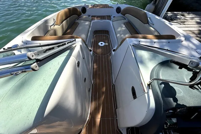 Slide: The Image of 2007 Sea Ray 260 Sundeck interior with brown seating and wooden flooring. - 18