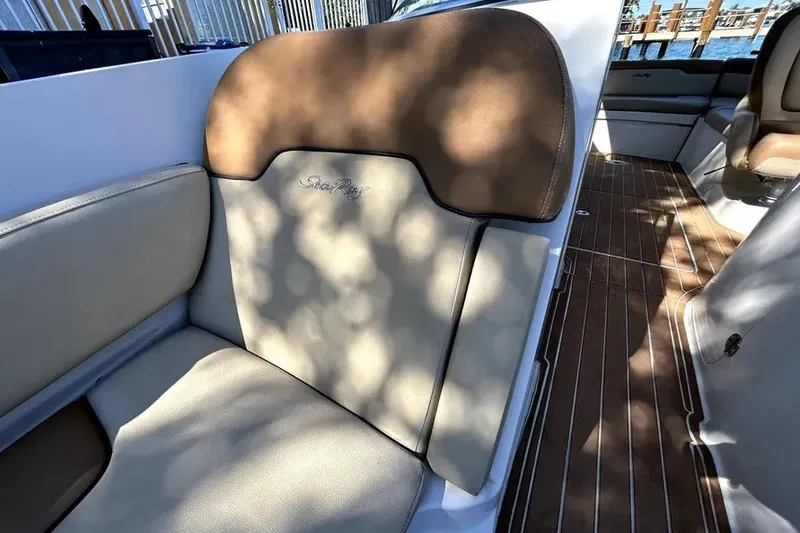 Slide: The Image of 2007 Sea Ray 260 Sundeck interior with beige and brown seating, wooden flooring. - 85