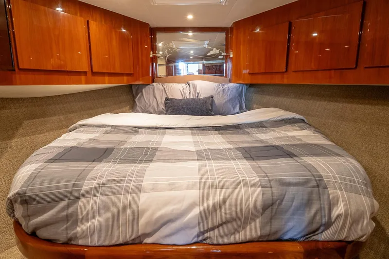 Slide: The Image of Luxurious cabin interior of 2003 Egg Harbor 42 Convertible yacht with cozy bedding. - 19
