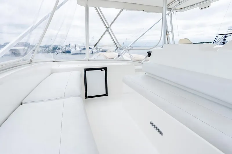 Slide: The Image of 2003 Egg Harbor 42 Convertible yacht interior with white seating and clear windows. - 27