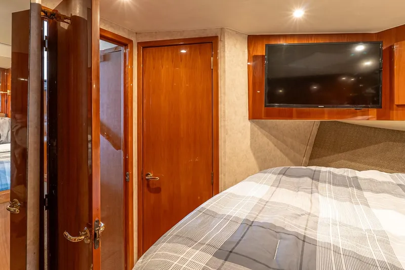 Slide: The Image of Interior of 2003 Egg Harbor 42 Convertible yacht with wood paneling and mounted TV. - 20