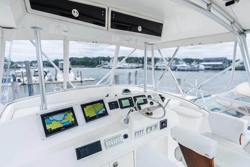 Slide: The Image of 2003 Egg Harbor 42 Convertible yacht helm with navigation screens and marina view. - 30