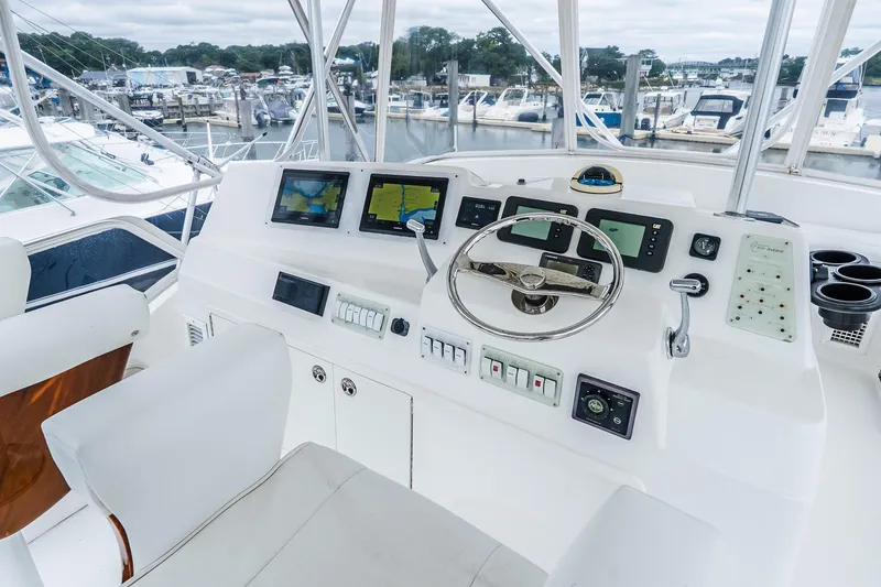 Slide: The Image of 2003 Egg Harbor 42 Convertible yacht helm with navigation screens and controls. - 31