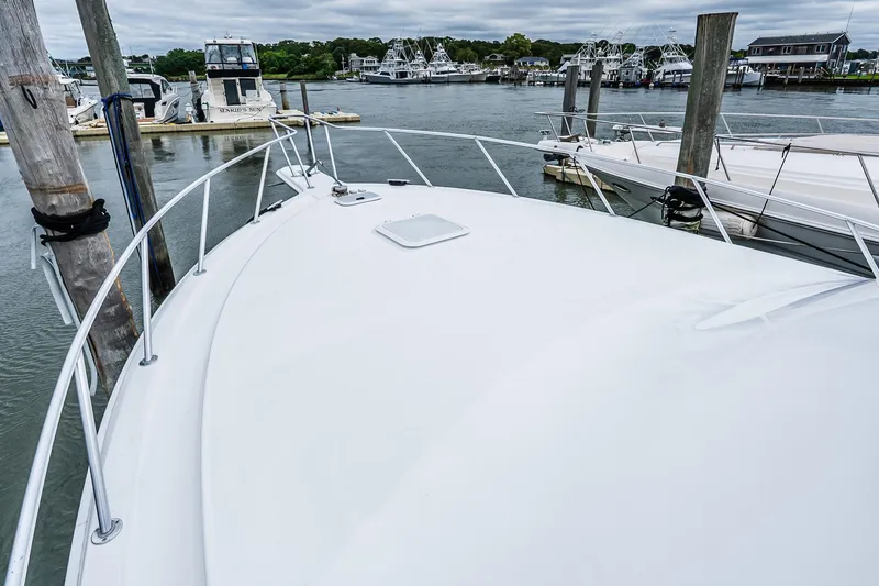 Slide: The Image of 2003 Egg Harbor 42 Convertible yacht docked at a marina, view from the bow. - 36