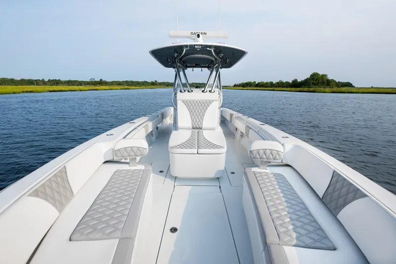 Slide: The Image of 2025 Contender 32 ST boat on calm water, featuring sleek design and luxurious seating. - 12