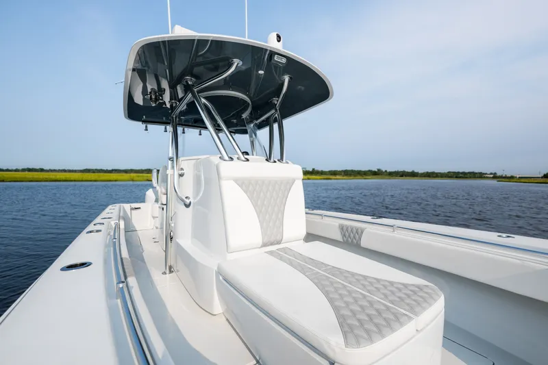 Slide: The Image of 2025 Contender 32 ST boat with sleek design on calm water. - 17
