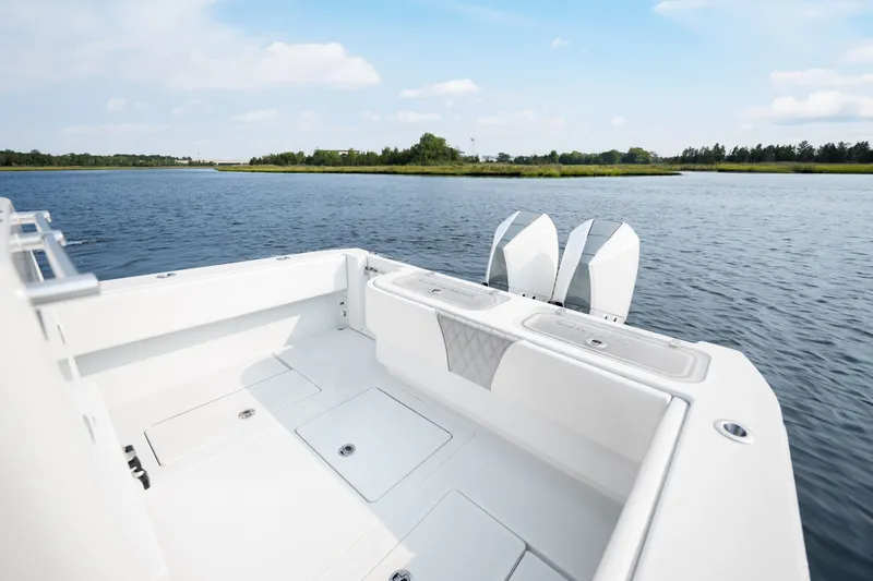 Slide: The Image of 2025 Contender 32 ST boat on calm water, featuring dual outboard motors. - 29