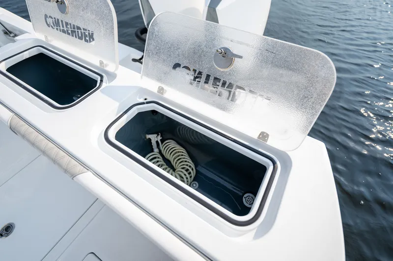 Slide: The Image of 2025 Contender 32 ST boat storage compartments with open lids, showcasing interior space. - 36