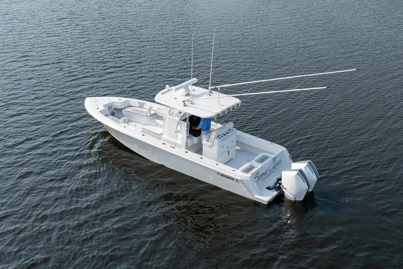 Slide: The Image of 2025 Contender 32 ST boat on calm water, featuring dual outboard engines. - 4