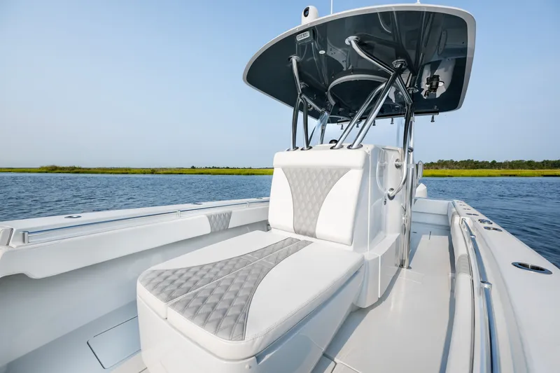 Slide: The Image of 2025 Contender 32 ST boat with sleek seating and modern design on calm water. - 15