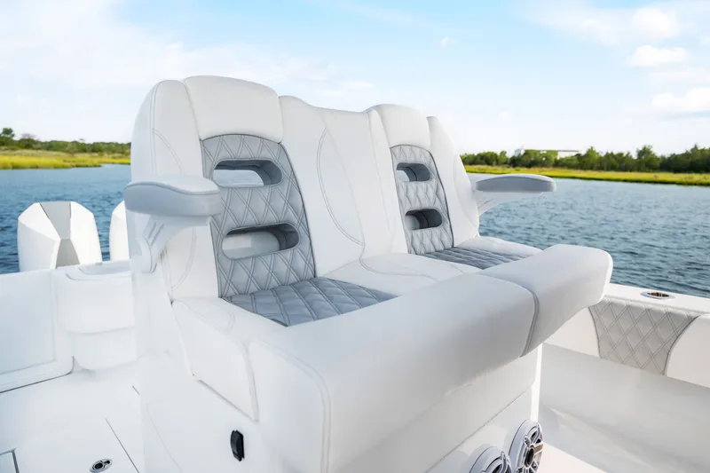 Slide: The Image of Luxury seating on 2025 Contender 32 ST boat, featuring elegant white and gray upholstery. - 27