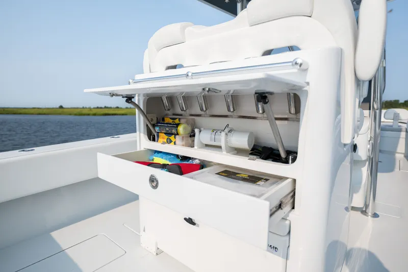 Slide: The Image of 2025 Contender 32 ST boat storage compartment with open drawers, showcasing organized gear. - 32