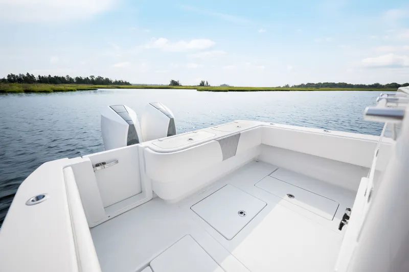 Slide: The Image of 2025 Contender 32 ST boat on calm water, showcasing spacious deck and dual engines. - 28