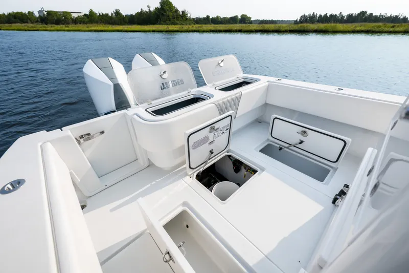 Slide: The Image of 2025 Contender 32 ST boat interior with open storage compartments on calm water. - 30