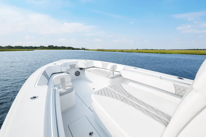 Slide: The Image of 2025 Contender 32 ST boat interior on calm water, showcasing sleek design and spacious seating. - 11