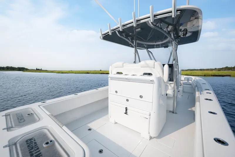 Slide: The Image of 2025 Contender 32 ST boat on calm water, featuring sleek design and spacious deck. - 31
