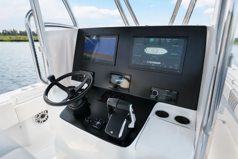 Slide: The Image of 2025 Contender 32 ST boat dashboard with advanced navigation screens and controls. - 24
