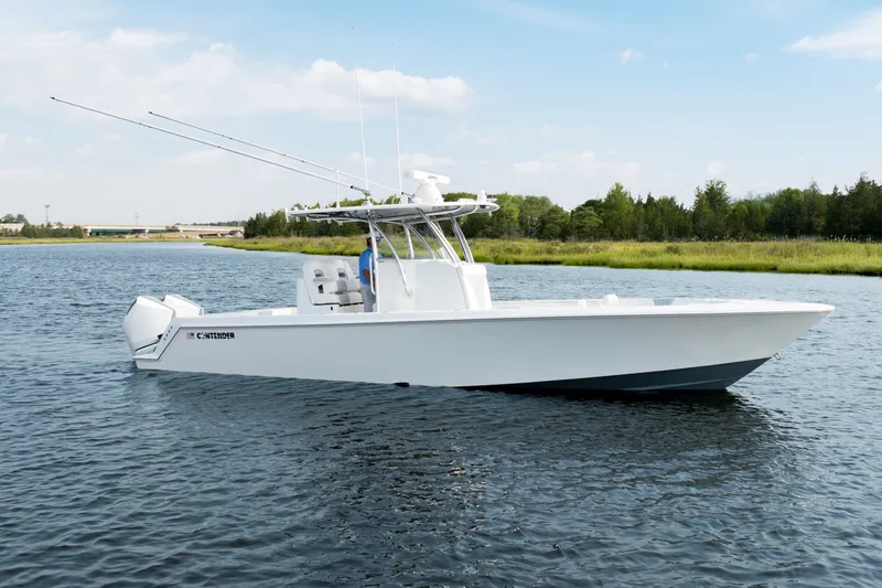 Slide: The Image of 2025 Contender 32 ST boat on calm water, featuring sleek design and modern amenities. - 2
