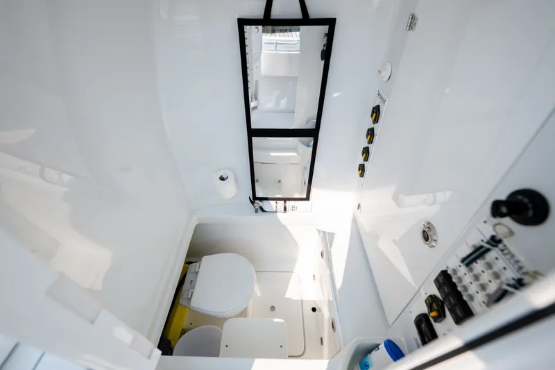 Slide: The Image of Interior of 2025 Contender 32 ST boat, featuring a compact, modern bathroom with essential amenities. - 37