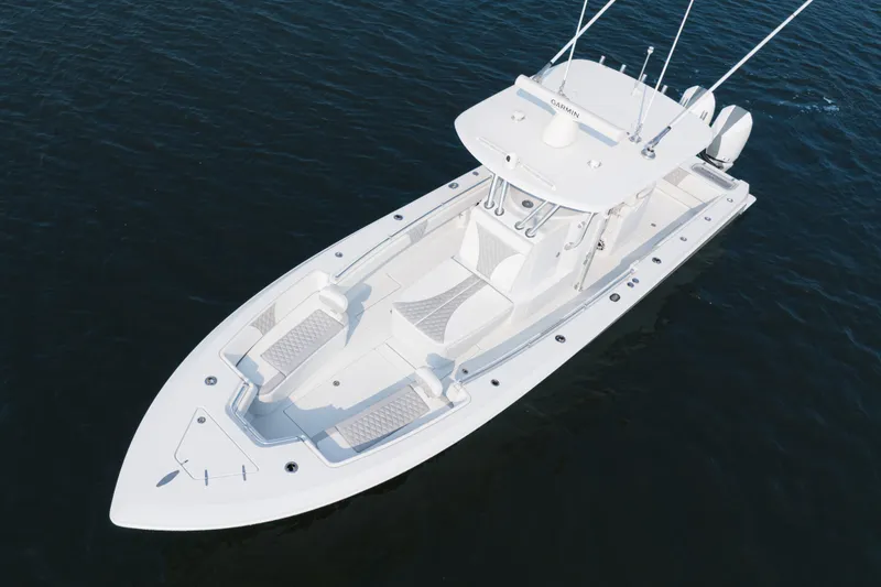 Slide: The Image of 2025 Contender 32 ST boat on water, aerial view, sleek design, white exterior. - 8
