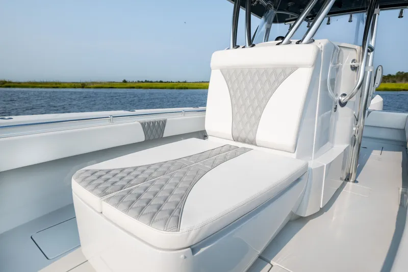 Slide: The Image of 2025 Contender 32 ST boat with luxurious seating on a calm water backdrop. - 16